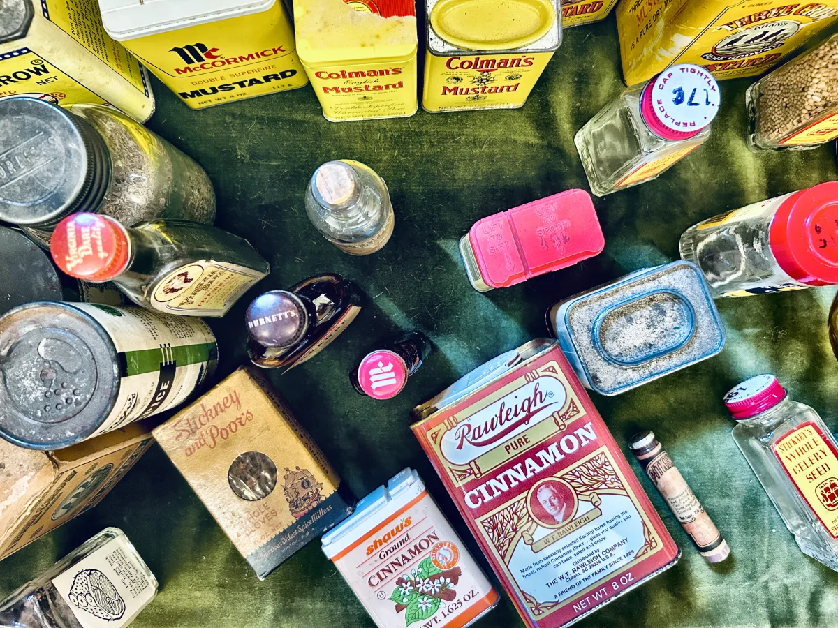 Overhead view of spice tins and bottles including Rawleigh cinnamon
