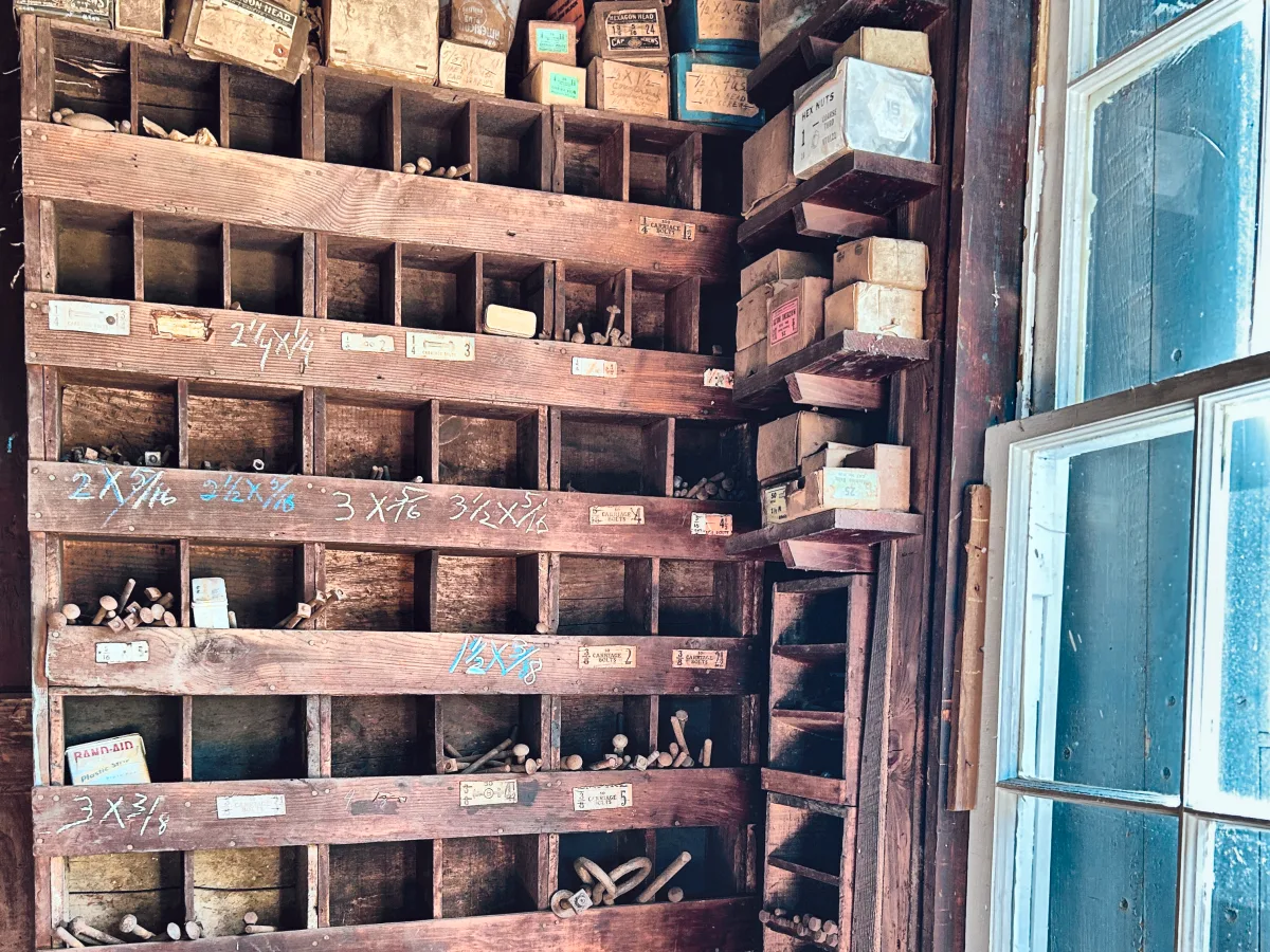 Wooden bins of bolts, nuts and cotter pins with old printed labels