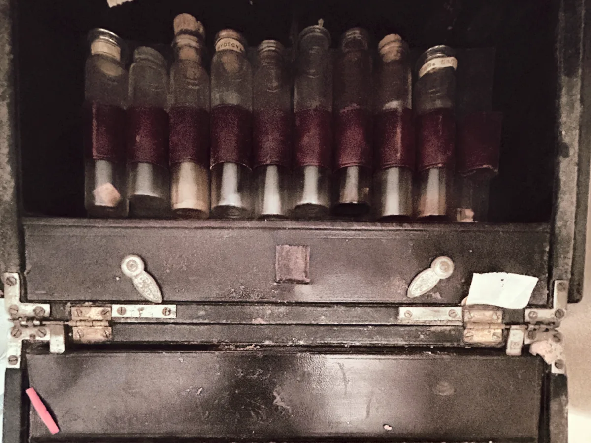 Fitted case of glass medicine vials with cork stoppers