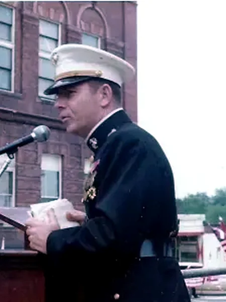 Portrait of an unidentified Vassalboro veteran speaking at a podium