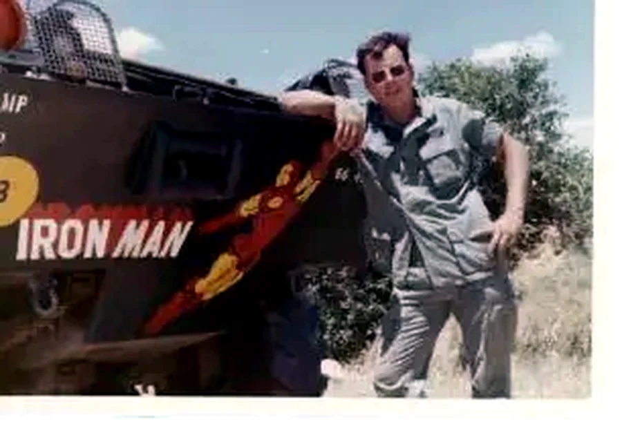 A Vassalboro veteran beside a military vehicle decorated with Iron Man artwork