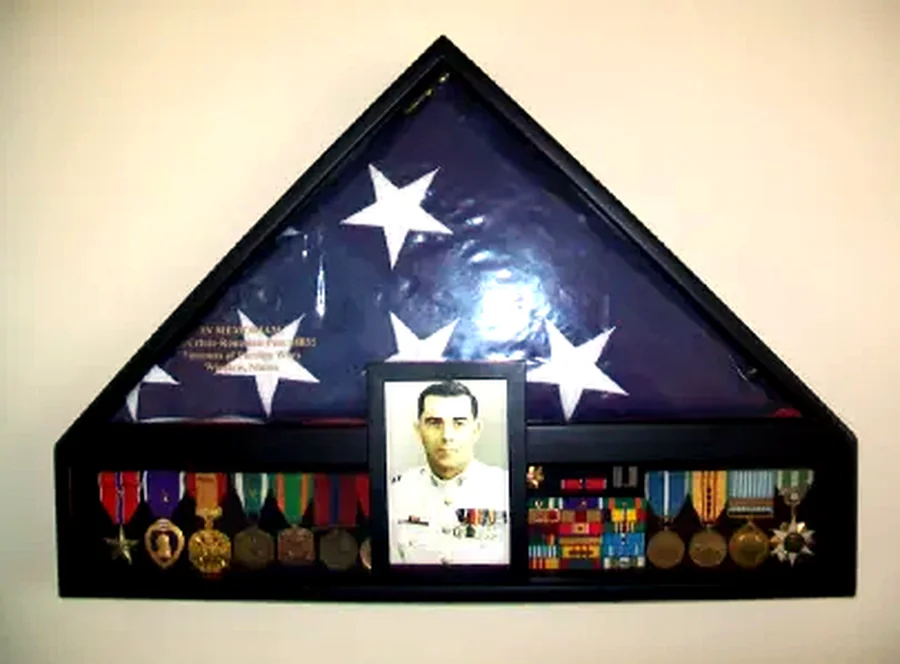 Edward G. Poulin's memorial flag shadow box, with medals and a service photo